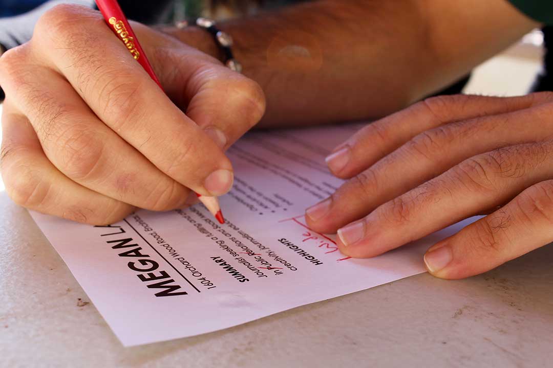 Front Porch, San Luis Obispo, Oct. 14, 2019｜DeSantis begins his editing process with a quick scan of the resumè. He assures LaChance that her resumè is a great start, but he quickly begins to identify areas for improvement. A copy edit reveals what DeSantis describes as “common mistakes:” wasted space, incorrect capitalization and inconsistencies in language. He drags a red pencil across the page to indicate these errors, one of which is wide margins—a problem he claims leads to underutilized space.